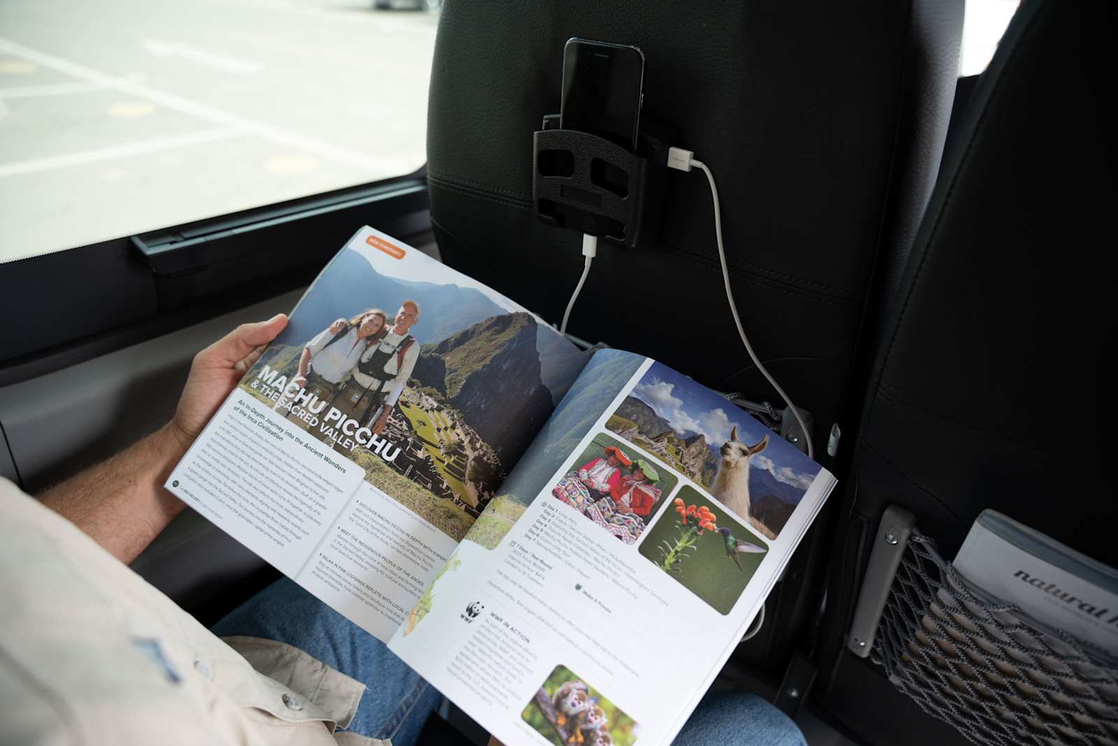 Inside Nat Hab's Electric Vehicle in Peru, a guest browses our cataloge. 
